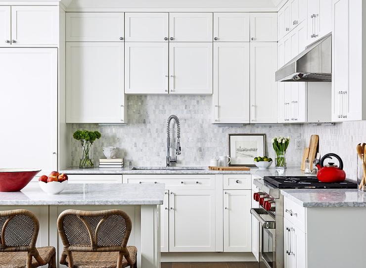 Stacked white shaker cabinets offer plenty of storage space. Design by Breeze Giannasio